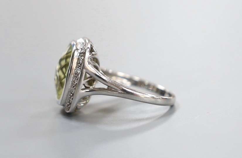 A modern 18k white metal, fancy cut quartz and diamond chip cluster set dress ring, size N, gross weight 7.4 grams.